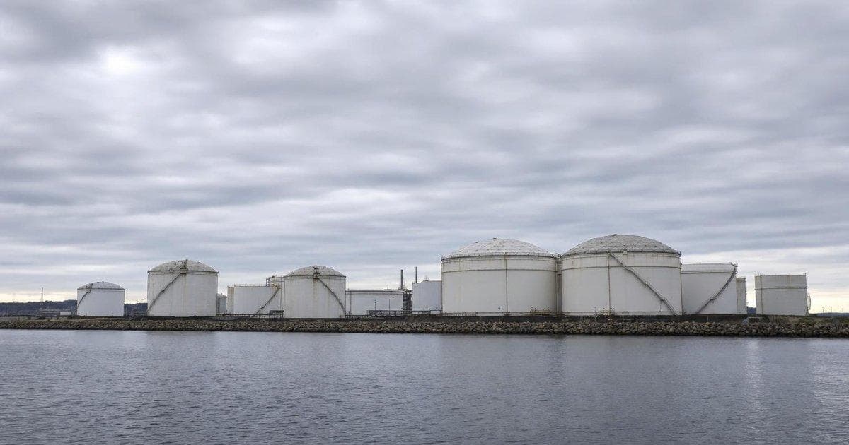 Crude oil storage tanks at a coastal terminal as diplomatic talks ease supply fears and pressure oil prices