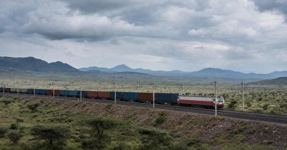 Modern freight train on upgraded East African railway line illustrating AfDB $650m Uganda rail backing