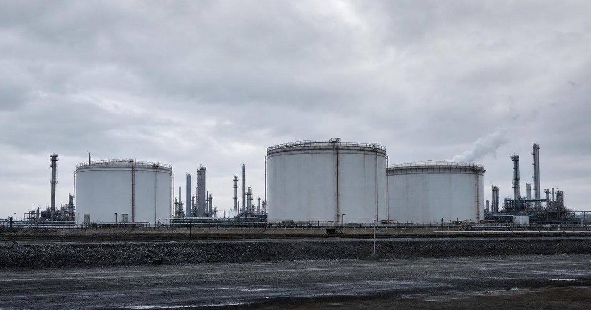 Oil storage tanks at a refinery highlight energy price risks as crude tops $100 and ECB warns on inflation