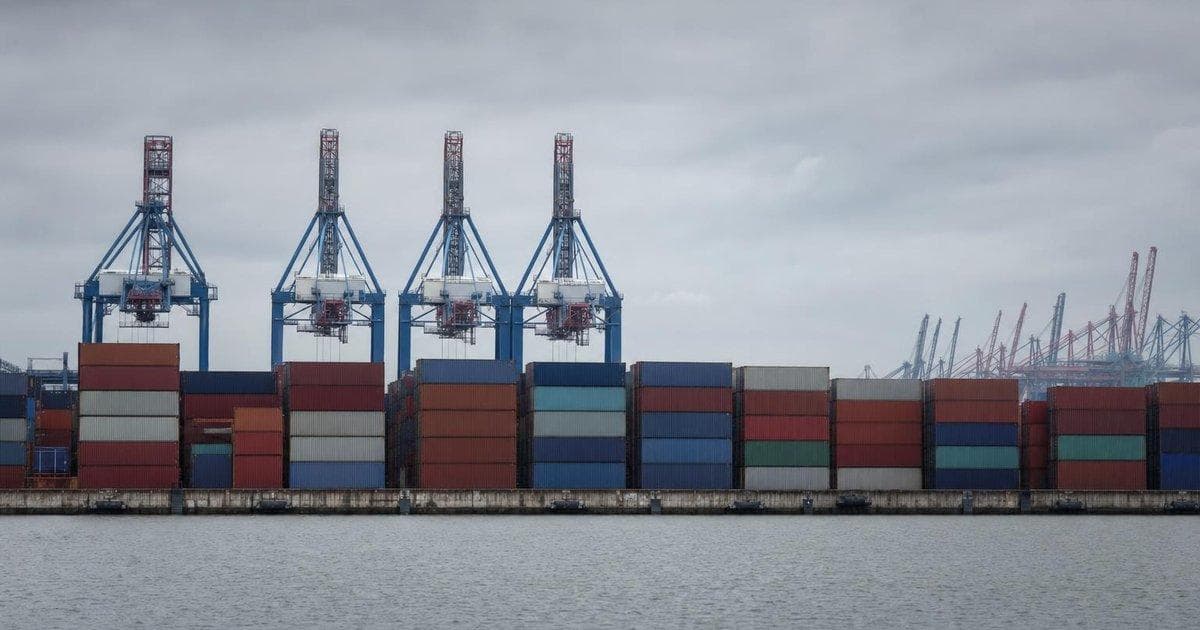 Stacked shipping containers at a major port illustrating EU trade stance on China and import tariffs