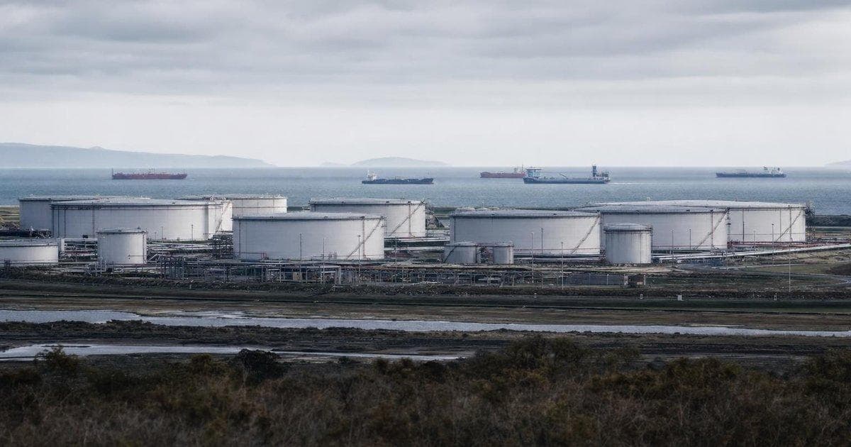 Oil storage tanks at a coastal terminal illustrating deepening India–Venezuela crude and energy ties