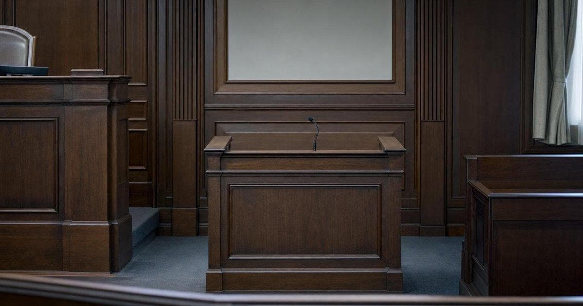 Empty witness stand in courtroom symbolizing fraud conviction of short seller in stock manipulation case