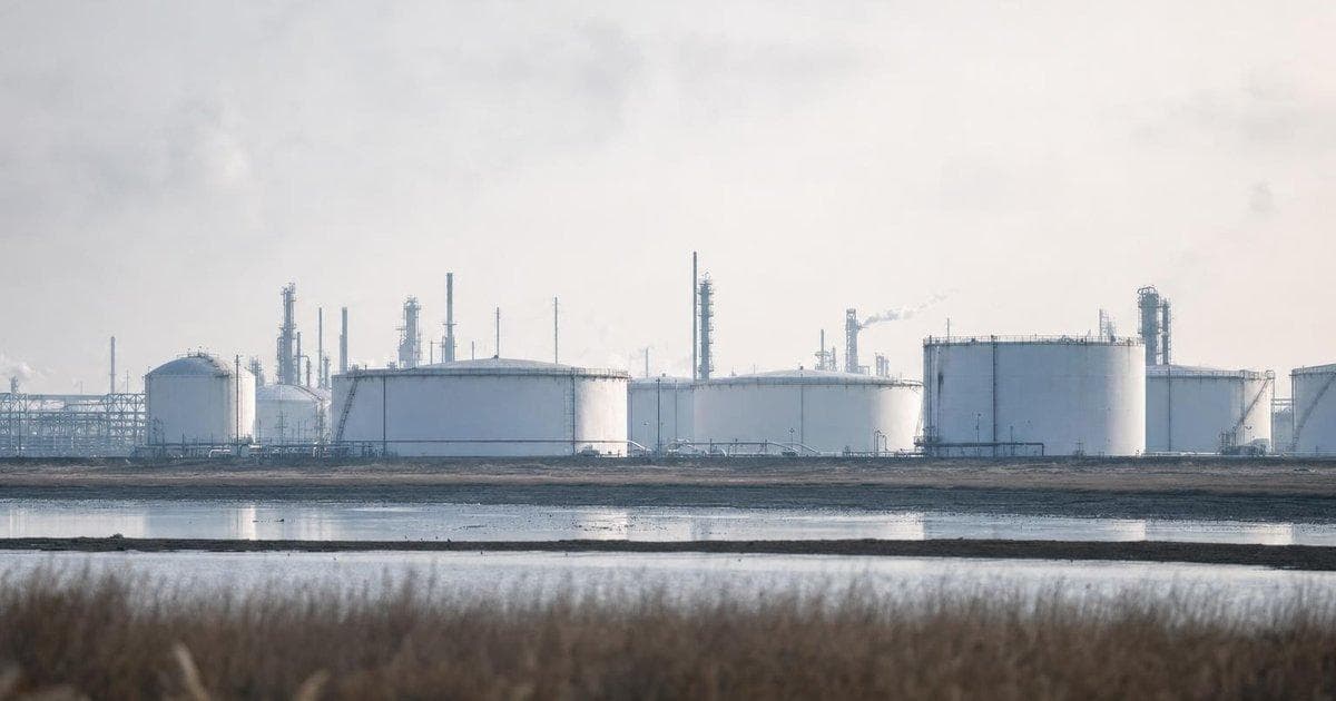 Oil storage tanks at a refinery symbolizing energy belt-tightening amid Gulf oil tensions