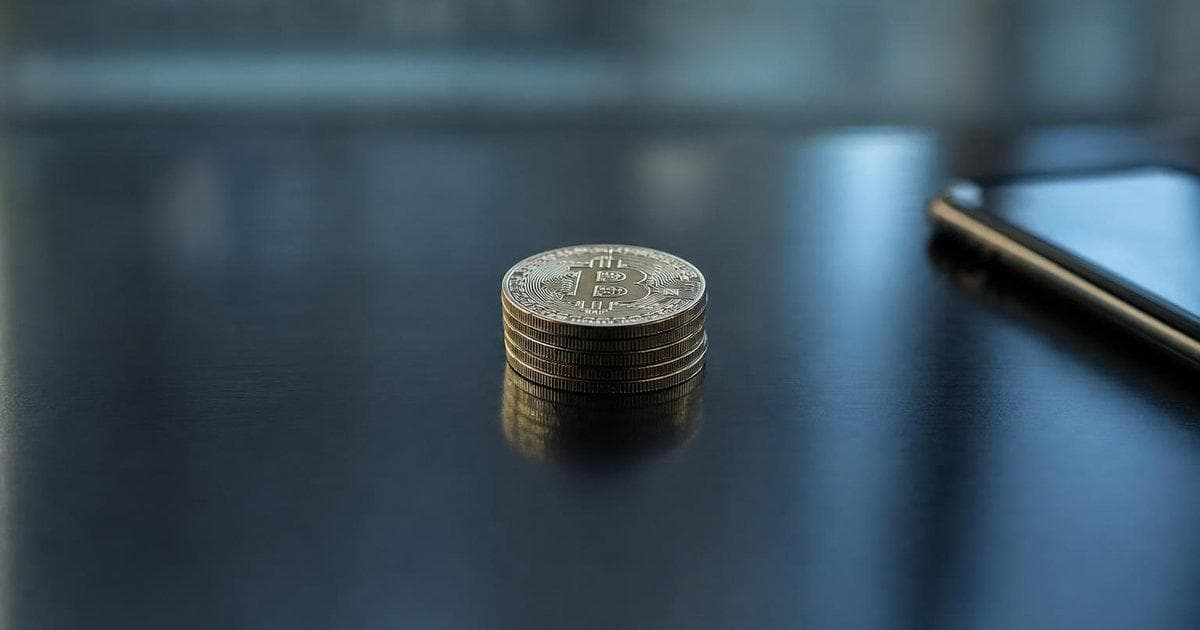 Stack of generic crypto coins on a desk amid scrutiny over £5m digital asset gift to politician