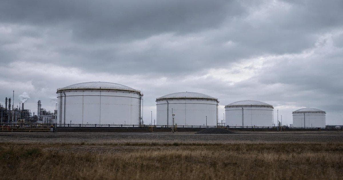 Crude oil storage tanks at an industrial terminal as oil climbs while S&P 500 and Nasdaq hit record highs