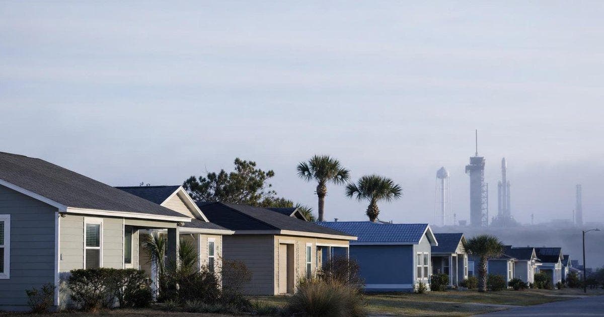 Modest homes near a rocket launch site reflecting local housing concerns around a major aerospace IPO