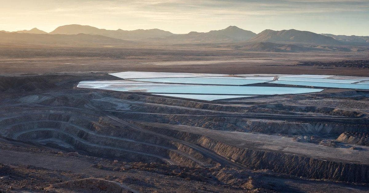 Lithium mine evaporation ponds in desert landscape as lithium outlook and growth guidance improve for SQM