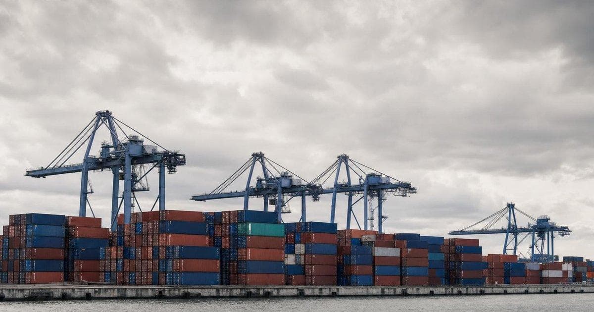 Shipping containers at a busy port illustrating narrowing US goods trade gap on export surge
