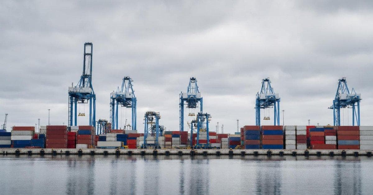 Shipping containers at a busy port illustrating narrowing US trade gap as exports rise