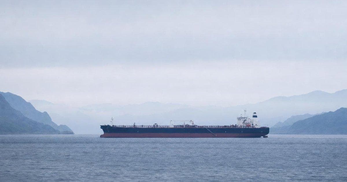 Oil tanker transiting a narrow Gulf shipping lane amid geopolitical tensions over US–Iran talks