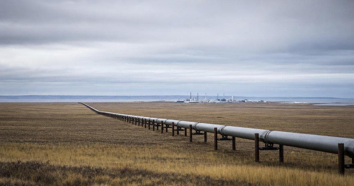 Oil refinery tanks under cloudy sky illustrating energy surge driving US producer prices higher