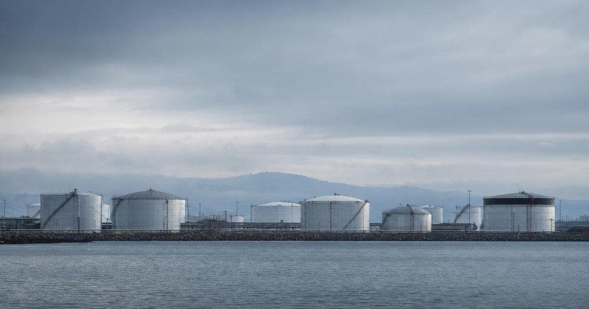 Oil storage tanks at a coastal terminal illustrating fuel-related economic strain from US sanctions on Cuba